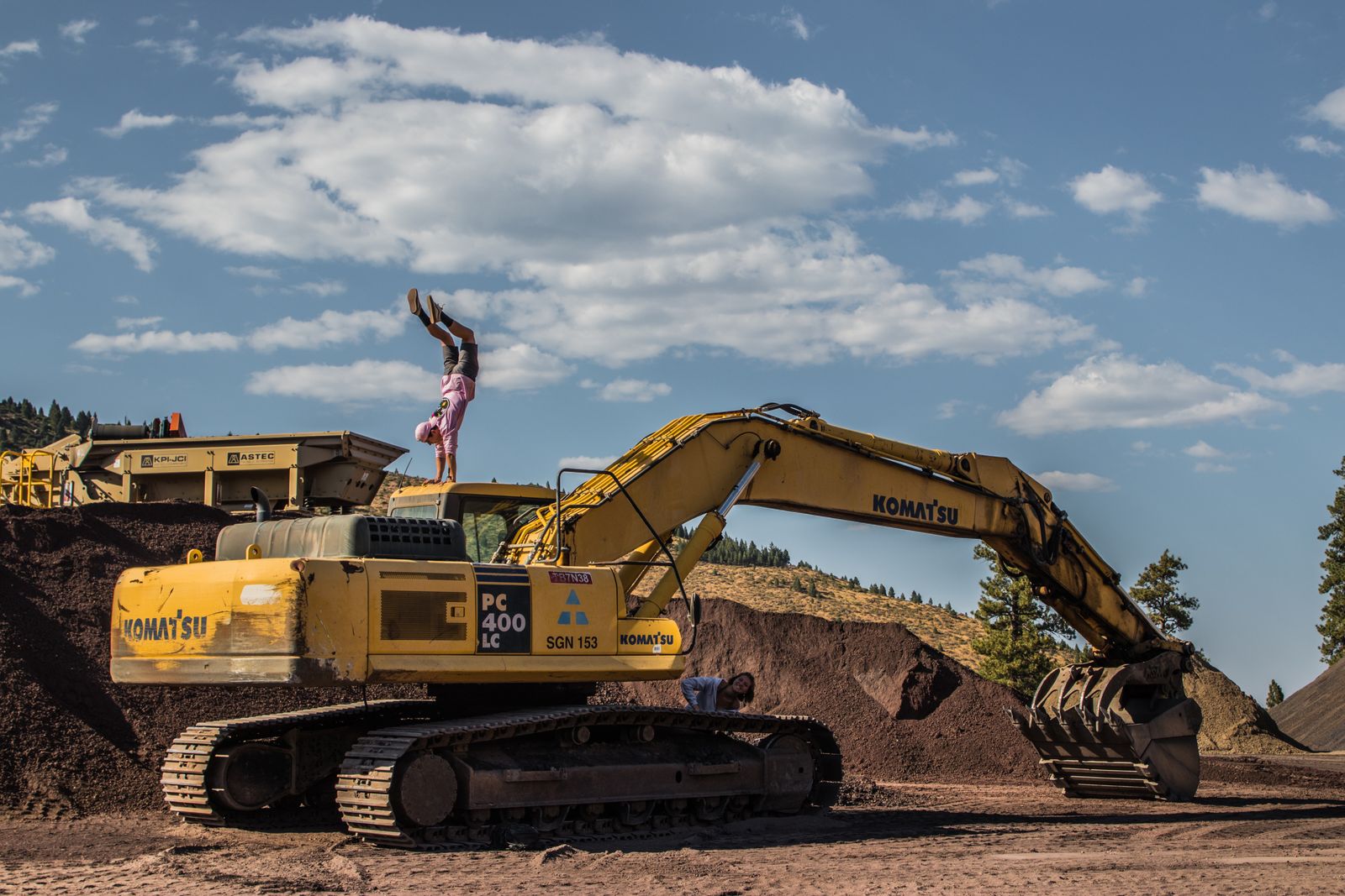 Excavators working an earth bank at a site.